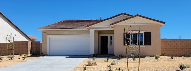 ranch-style house with a garage, fence, concrete driveway, and stucco siding