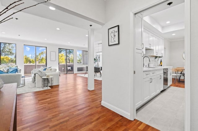 hall featuring sink and light hardwood / wood-style floors