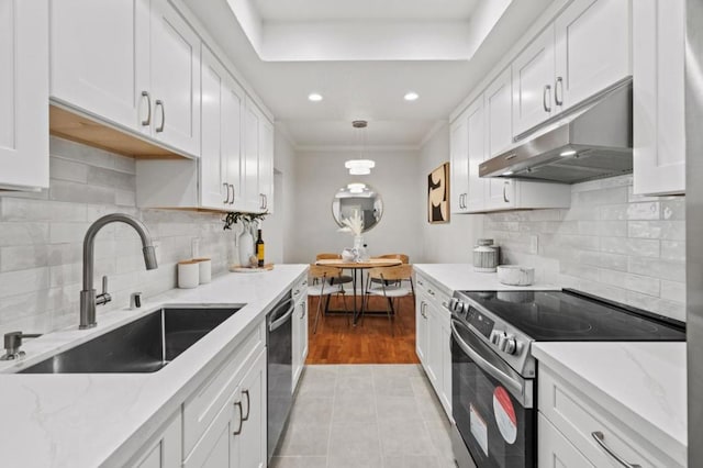 kitchen with sink, black dishwasher, white cabinets, decorative light fixtures, and stainless steel range with electric cooktop