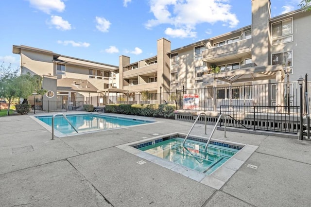 view of swimming pool with a community hot tub