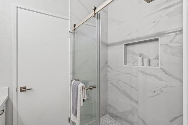 bathroom with vanity and a shower with shower door