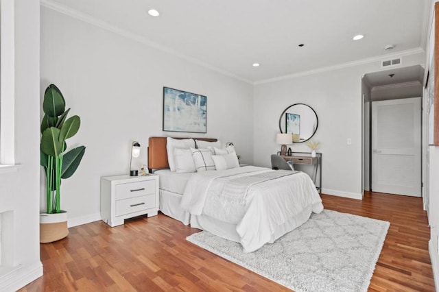 bedroom featuring ornamental molding and light wood-type flooring