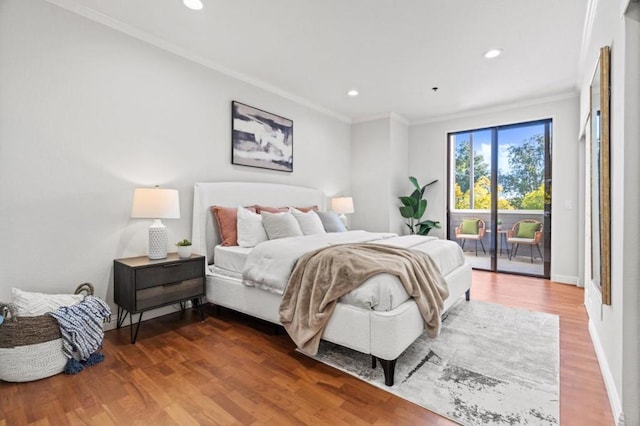 bedroom with hardwood / wood-style flooring, access to outside, and ornamental molding