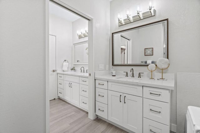 bathroom with vanity and hardwood / wood-style floors