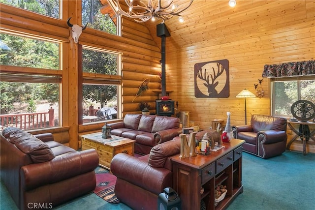 carpeted living room featuring a notable chandelier, a wood stove, rustic walls, and high vaulted ceiling