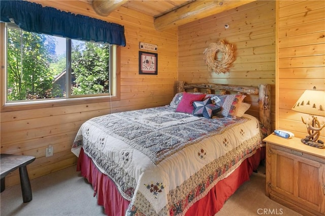 carpeted bedroom featuring beam ceiling and wood walls