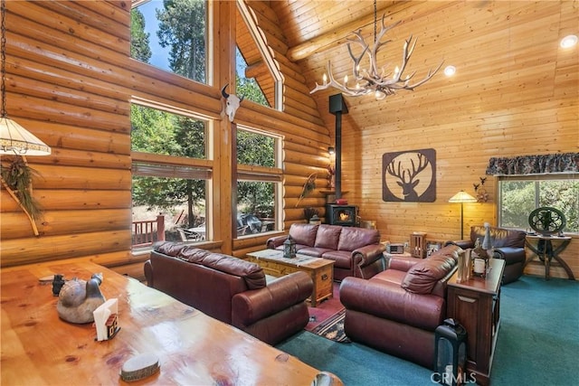 living room featuring rustic walls, an inviting chandelier, high vaulted ceiling, a wood stove, and carpet floors