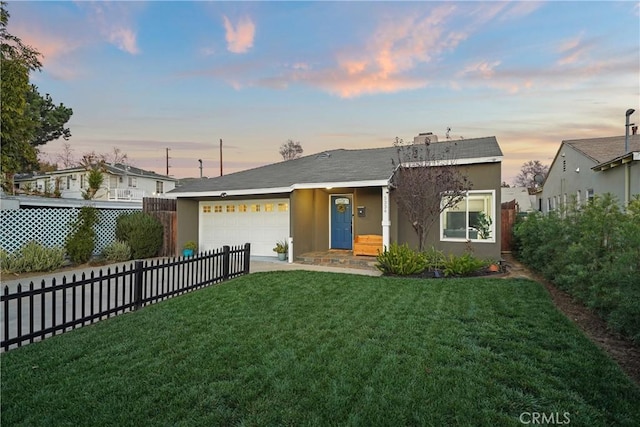 single story home featuring a yard and a garage