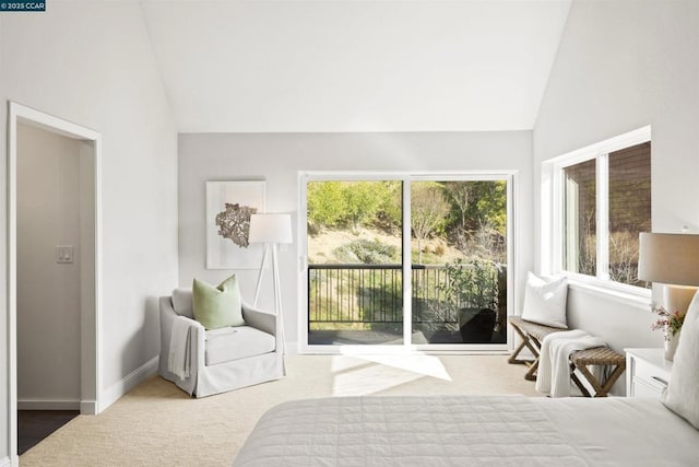 bedroom featuring access to exterior, vaulted ceiling, and light colored carpet