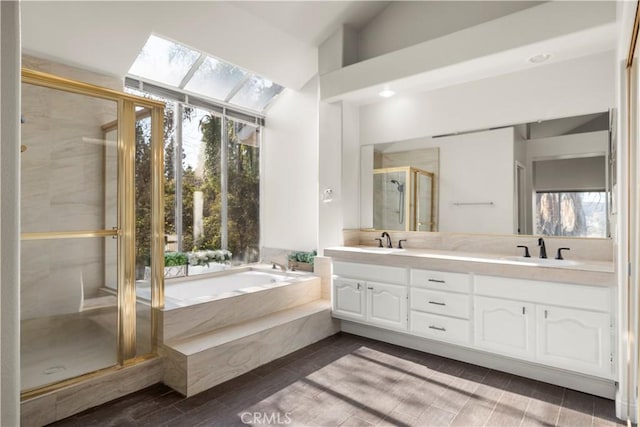 bathroom featuring shower with separate bathtub, lofted ceiling, and vanity