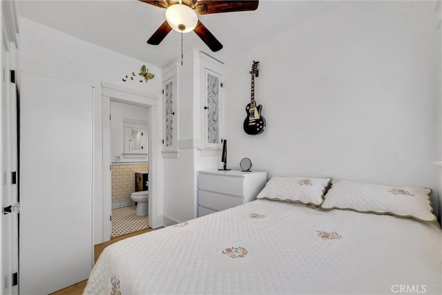 bedroom with connected bathroom and ceiling fan