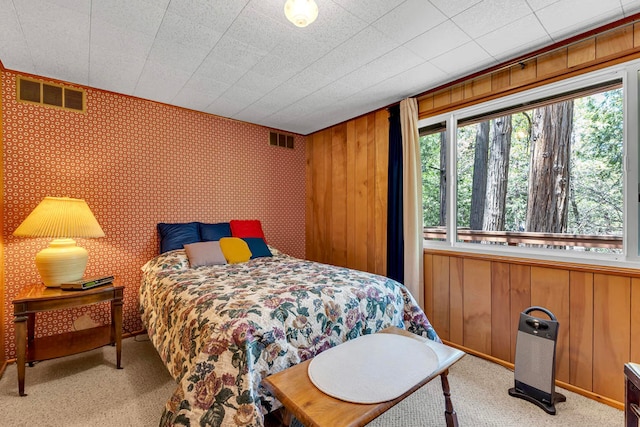 carpeted bedroom featuring multiple windows