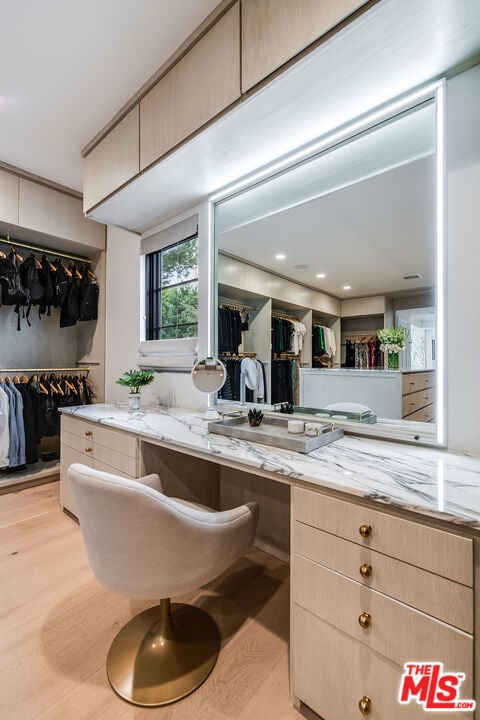 interior space featuring light stone countertops, light hardwood / wood-style flooring, and light brown cabinets