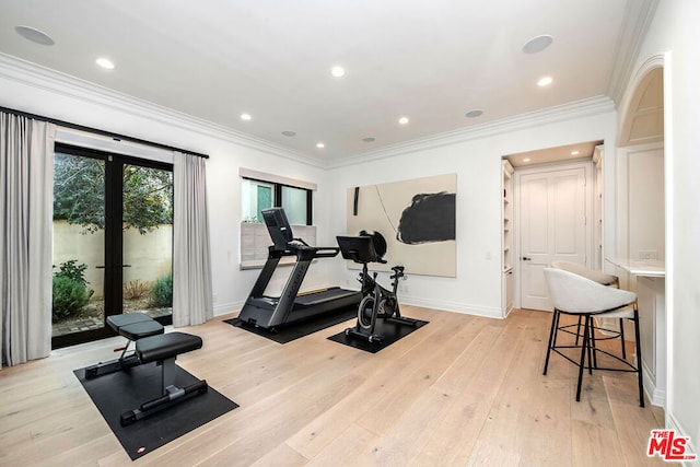 exercise room with ornamental molding, french doors, and light wood-type flooring