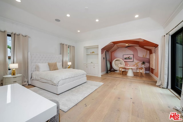 bedroom with light hardwood / wood-style flooring, ornamental molding, and a raised ceiling