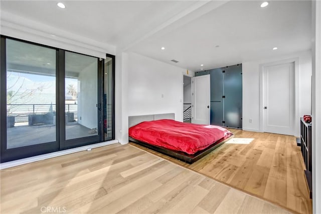 bedroom with hardwood / wood-style flooring and access to outside