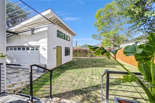 view of home's exterior featuring a garage and a yard