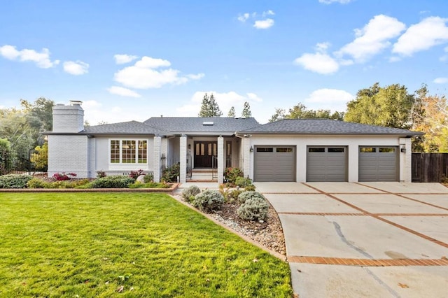 view of front of property with a garage and a front yard