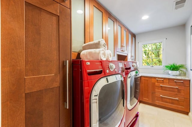 laundry area featuring cabinets and separate washer and dryer