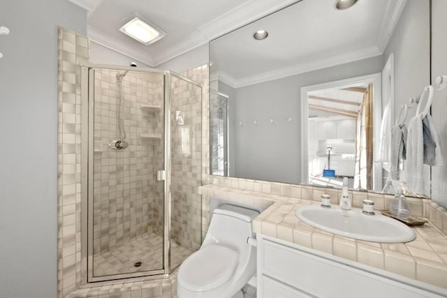 bathroom with crown molding, toilet, vanity, and a shower with shower door