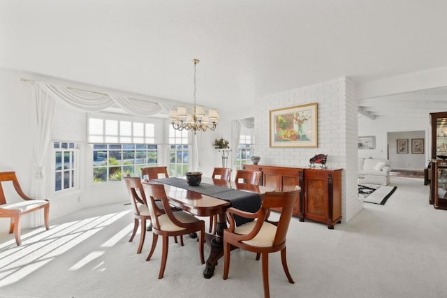 dining space with light colored carpet and a notable chandelier