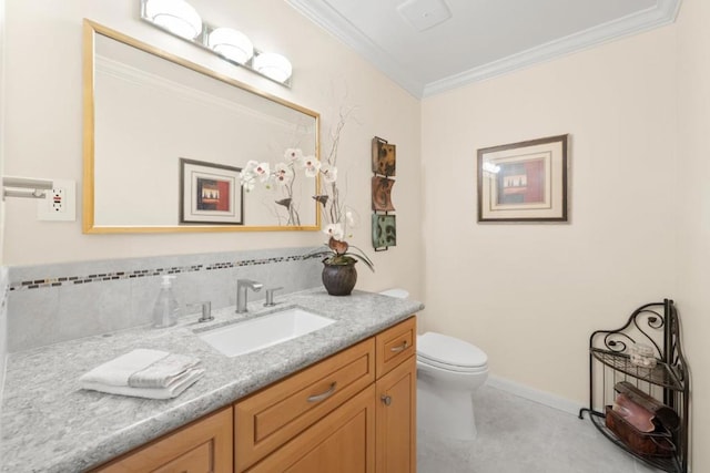 bathroom with vanity, ornamental molding, and toilet