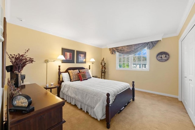 bedroom featuring a closet, ornamental molding, and light carpet