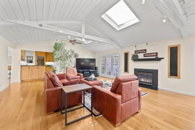 living room with wooden ceiling, vaulted ceiling with skylight, track lighting, and light wood-type flooring