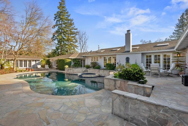 view of swimming pool featuring an in ground hot tub and a patio area