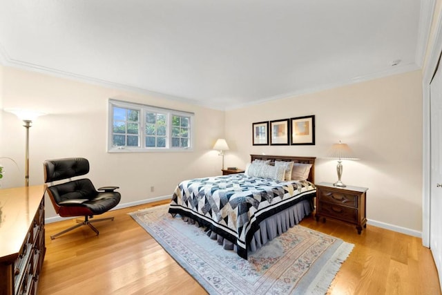 bedroom featuring ornamental molding and light wood-type flooring