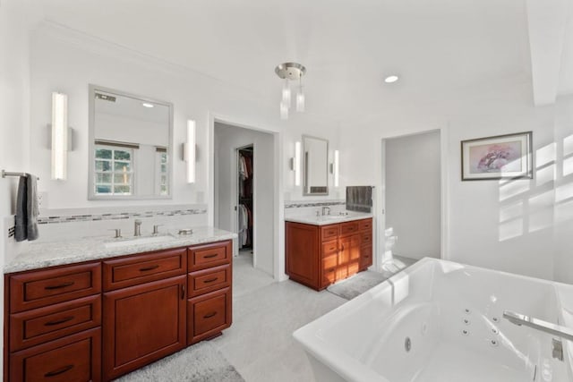 bathroom featuring vanity, ornamental molding, decorative backsplash, a tub, and toilet