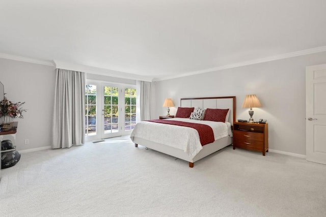 carpeted bedroom featuring access to exterior, crown molding, and french doors