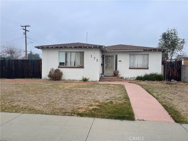 ranch-style house with a front lawn