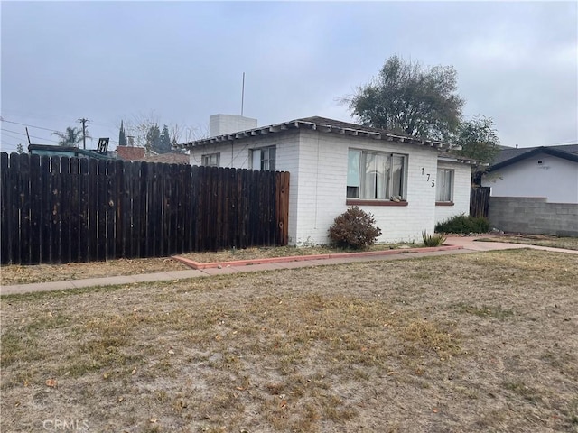 view of property exterior with a yard