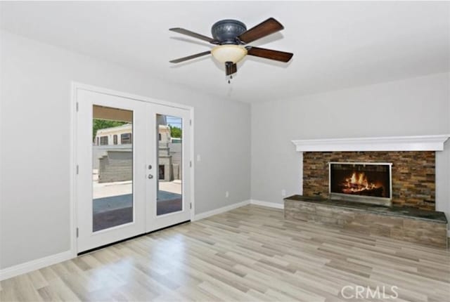 unfurnished living room featuring french doors, ceiling fan, and light wood-type flooring