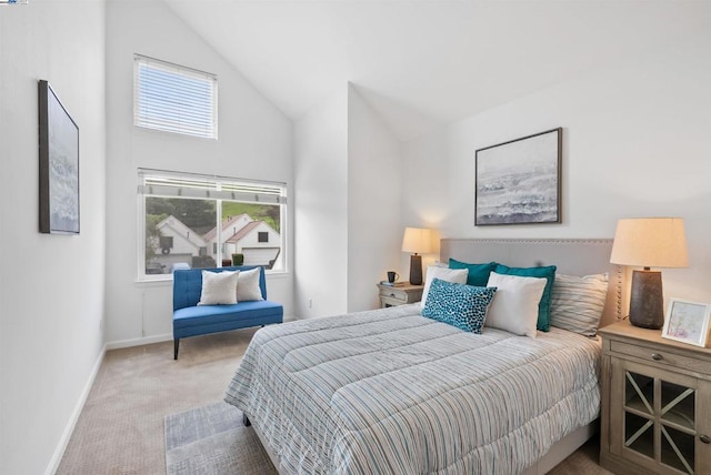 bedroom featuring high vaulted ceiling and light carpet