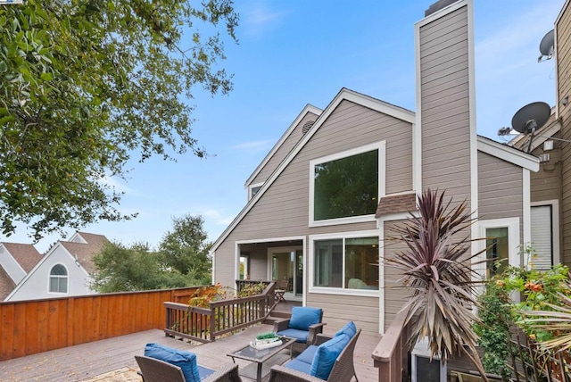 back of property featuring an outdoor living space and a deck