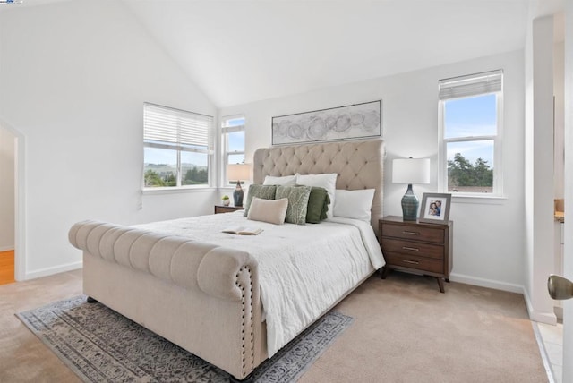 bedroom featuring lofted ceiling and light colored carpet