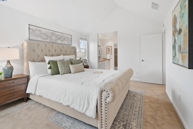 bedroom with light carpet, connected bathroom, and high vaulted ceiling