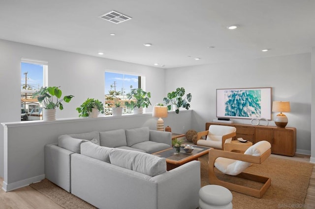 living room with plenty of natural light and light hardwood / wood-style floors