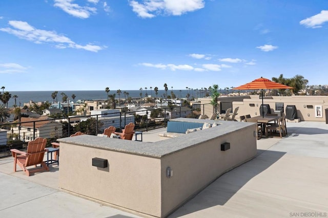 view of patio featuring a water view and an outdoor bar