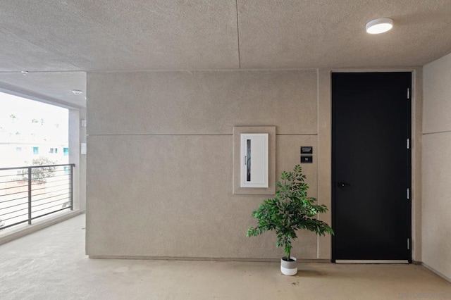 interior space with concrete floors and a textured ceiling