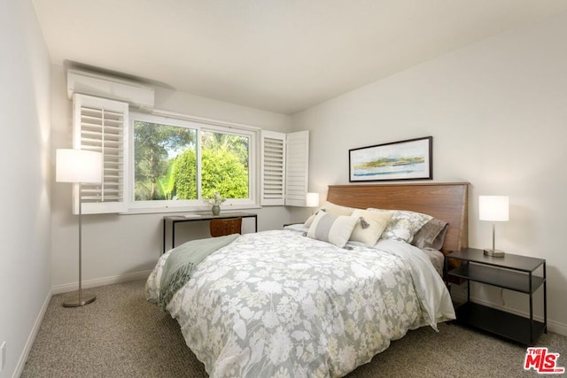 carpeted bedroom featuring an AC wall unit