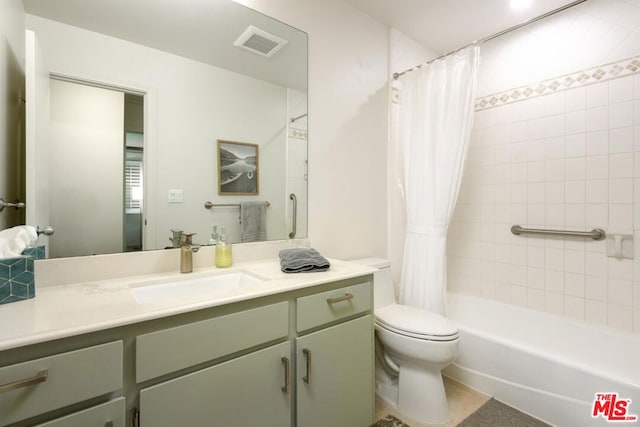 full bathroom with vanity, shower / bath combination with curtain, and toilet