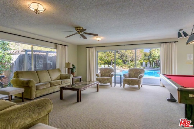 living room with ceiling fan, pool table, carpet, and a textured ceiling