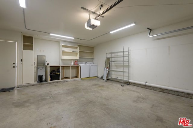 garage with a garage door opener and washing machine and dryer