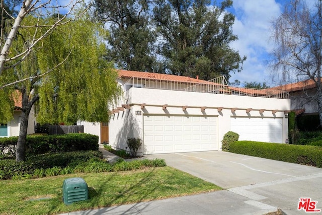 view of front of house featuring a garage and a balcony