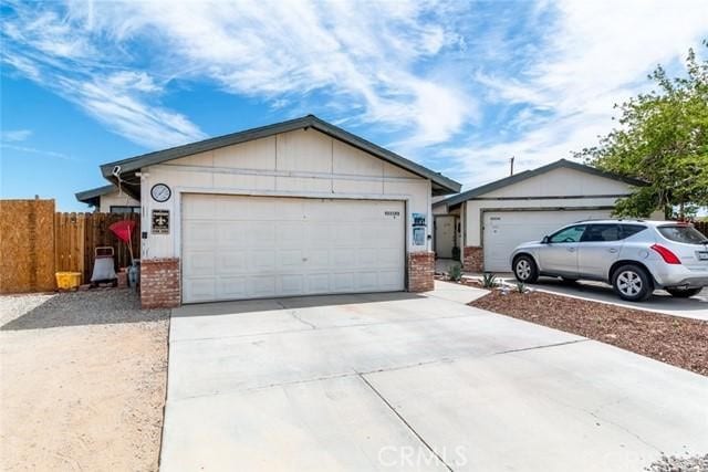 single story home featuring an outbuilding and a garage