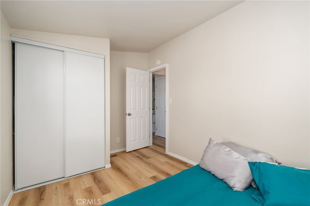 bedroom with a closet and light wood-type flooring