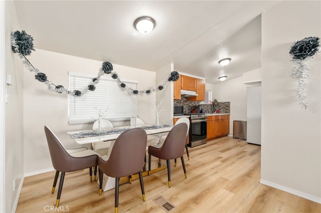 dining room with light hardwood / wood-style flooring